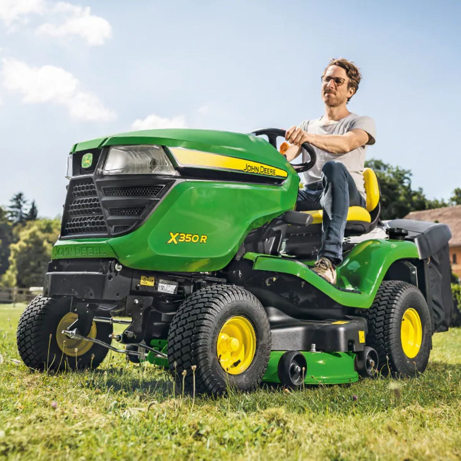 man riding green and yellow ride on lawn mower