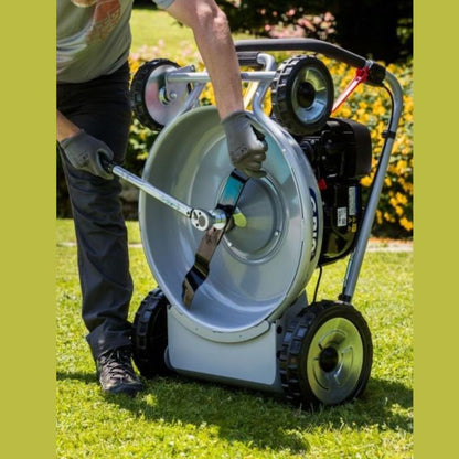 Man_looking_at_blades_of_Grin_Mulching_lawnmower_-_PM53A