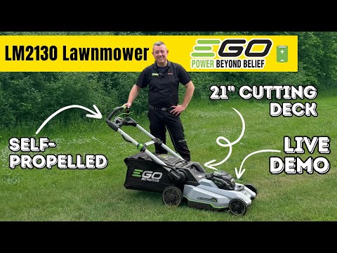 Man standing behind a grey and black lawnmower