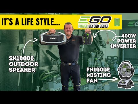 Man holding speaker and battery inverter in a garden machinery shop