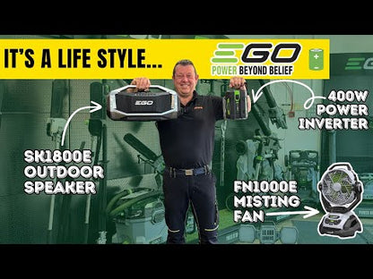 Man holding speaker and battery inverter in a garden machinery shop
